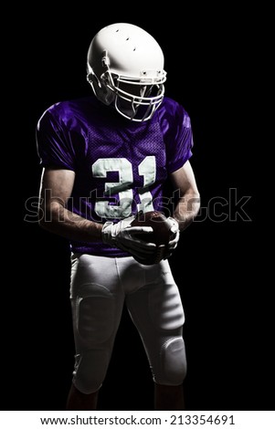 Football Player on a purple uniform, on a black background.