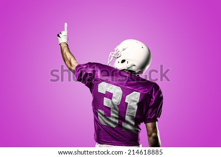 Football Player on a pink uniform celebrating on a pink background.