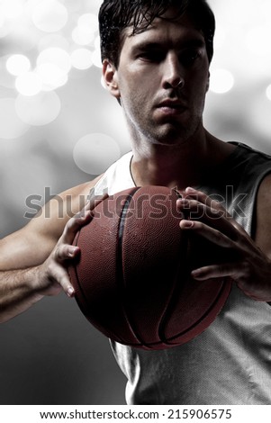 Basketball player on a  white uniform, on a white lights background.