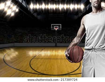 Basketball player on a  white uniform, on a basketball court.
