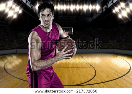 Basketball player on a  pink uniform, on a basketball court.