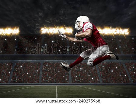 Football Player with a red uniform Running on a stadium.