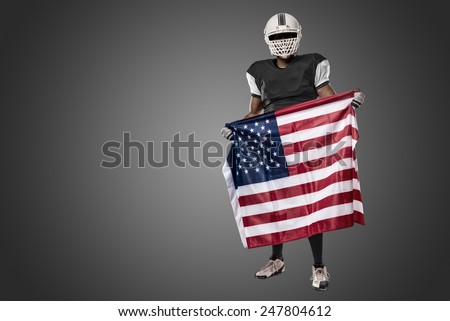 Football Player with a black uniform and a american flag, on a black background.