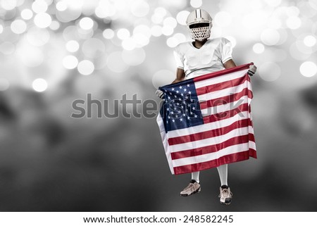 Football Player with a white uniform and a american flag, on a white lights background.