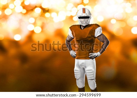 Football Player with a orange uniform on a orange lights background.