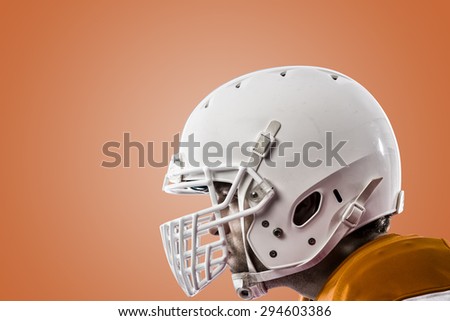 Close up of a Football Player with a orange uniform on a orange background.
