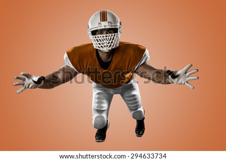 Football Player with a orange uniform making a tackle on a orange background.