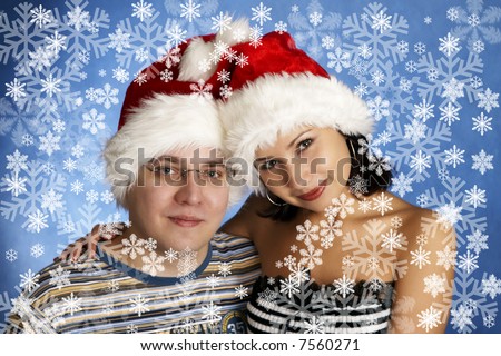 happy family wearing Santa Claus hats and snowflake frame