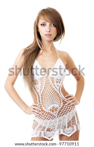 Sexy model posing in a studio in a handmade knitted dress isolated on white