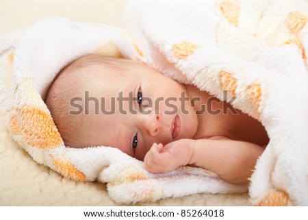 Baby face with soft cover on sheep leather