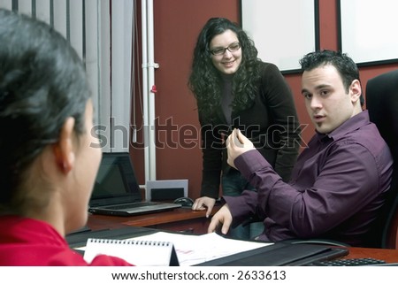 Businessman having talk with young women- discussion