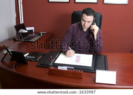 Businessman in office writing document