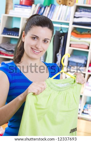 housewife putting clothes on available space, hanger, shelves