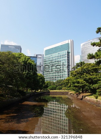 TOKYO, JAPAN - SEP 28: Hamarikyu Gardens and modern buildings in Tokyo, Japan on September 28, 2015. Tokyo is both the capital and largest city of Japan.