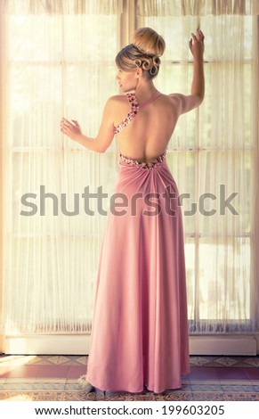 back of a pretty woman in a pink dress