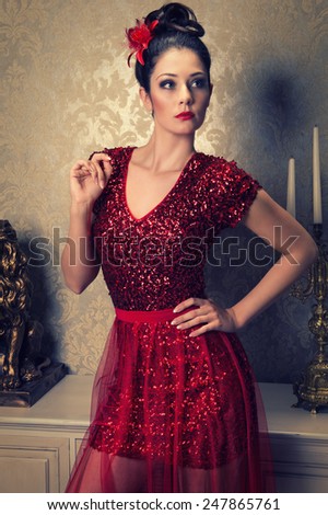 attractive brunette woman in a short red sequined cocktail dress