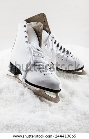Ice skates with cap on the snow