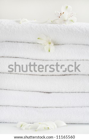 White towels decorated with white flowers for wellness