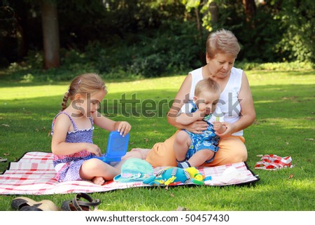 Kids have a small picnic with grandma
