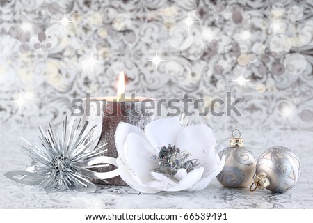 Christmas still life with candle and balls in silver tone with copyspace for your text