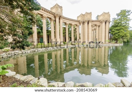 A view of the dome rotunda of the Palace of Fine Arts in San Francisco, California, United States of America. A colonnade roman greek architecture with statues and sculptures build around a lagoon.