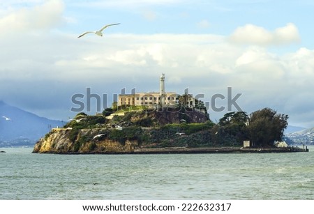 The Alcatraz Penitentiary, now a museum, in San Francisco, California, United States of America. A view of the island, the lighthouse, prison buildings and the Bay from the coast on a sunny day.