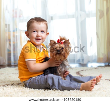 kid hugging puppy indoor