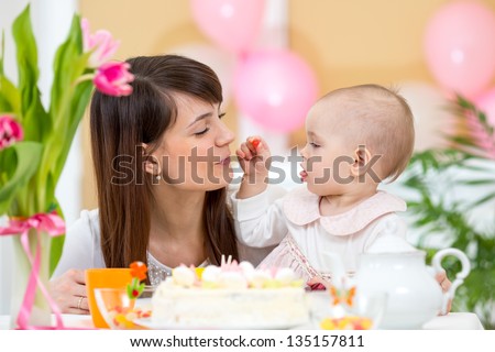 Baby and mother celebrate first birthday holiday
