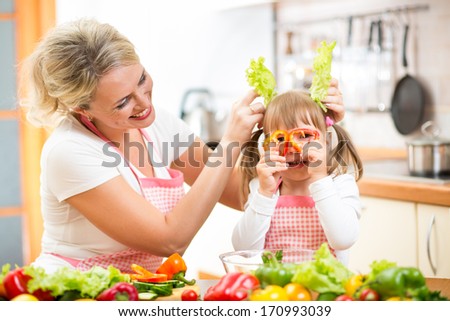 mother and kid cooking and having fun in kitchen