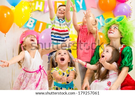 children group with clown celebrating  birthday party