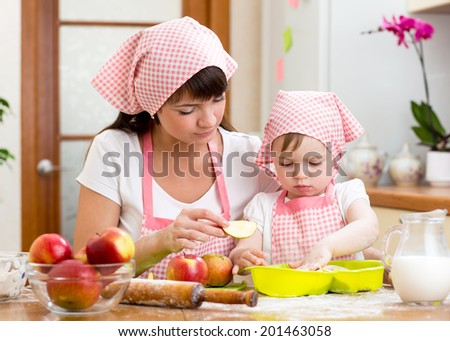 Mother and daughter making apple pie together