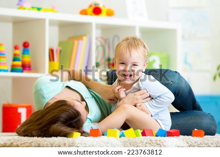 mother and child boy playing together indoor