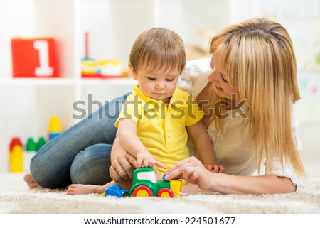 mother and baby playing with toy indoor