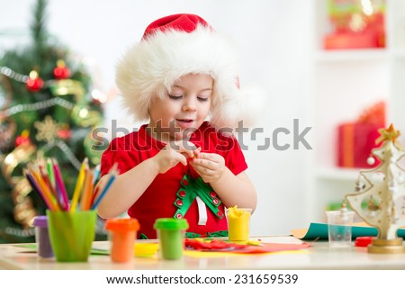 child girl making by hands christmas decorations