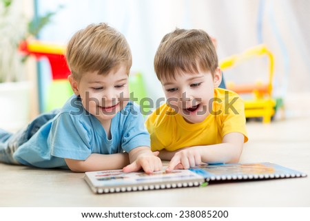 happy kids boys brothers reading together at home