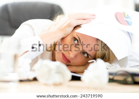 Businesswoman under pile of documents surrounded crumpled papers