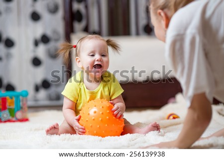 mom playing ball with baby indoor at home