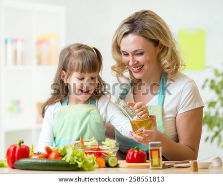 mother and kid girl preparing healthy food at home
