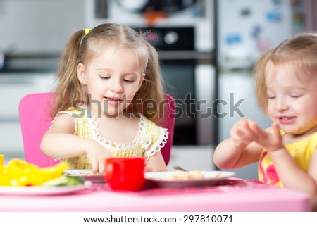 Cute children eat healthy food in nursery or at home