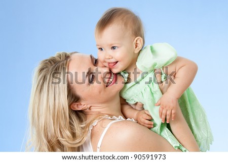 Rear view of mother with cute baby girl looking over shoulder