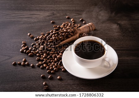 Coffee beans and hot coffee on the table