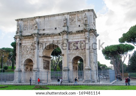 ROME-DEC 1, 2012: Tourists around the Arch of Constantin on Dec 1, 2012 in Rome. The Arch of Constantin, next to the Colosseum, is one of the best preserved monuments of the Rome