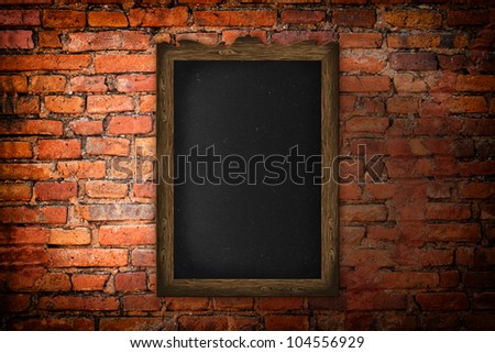 Blank blackboard on a brick wall background.