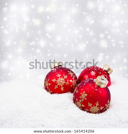 Three red christmas balls on silver background