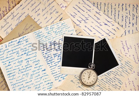 Blank photo frames on wallpaper background with old letters, watch