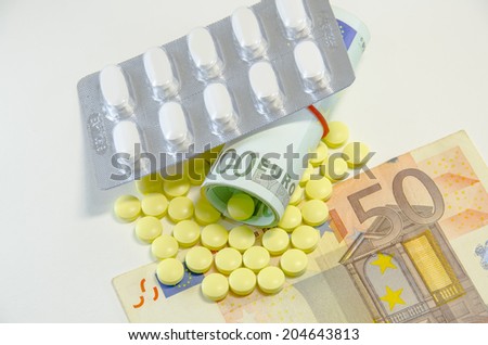 euro banknotes and tablets, symbol photo for costs of medications and health insurance.
