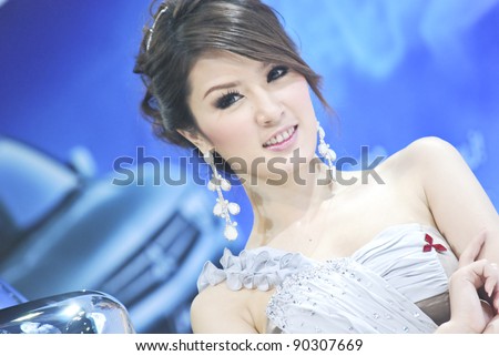 BANGKOK - DECEMBER 3: Female presenters model at the Mitsubishi booth during Bangkok International Motor Show at Impact Challenger on December 3, 2011 in Bangkok, Thailand.