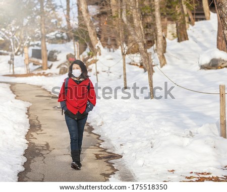 girl walking along a winter road