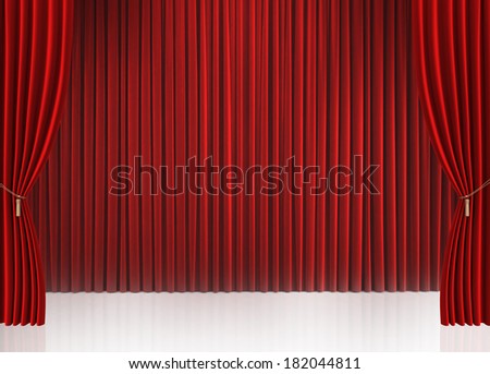 Red closed curtain with light spots in a theater