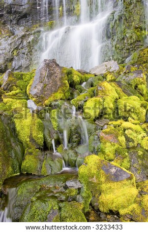 Waterfall with green mossy rocks and stones